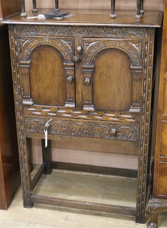 A 17th century style oak cupboard W.67cm